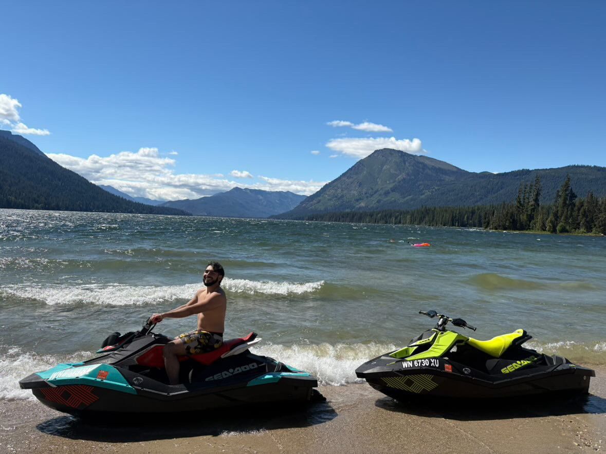 Rider looking back from a jet ski with mountains in the distance